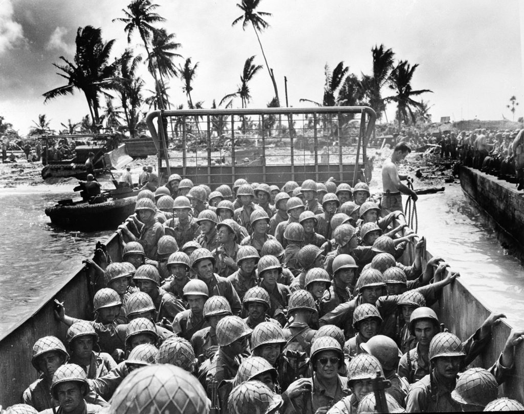 A landing craft packed with Marines approaches an island in the Kwajalein Atoll during the U.S. invasion of the Marshall Islands on March 2, 1944. Ralph Eyde and the 7th Infantry Division also took part in the difficult fighting.